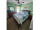 Main bedroom with king-size bed, dresser and ceiling fan at 2605 Emerald Island Blvd, Kissimmee, FL 34747
