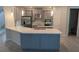 Spacious kitchen with large island and white countertops at 3937 Reed Grass Pl, Kissimmee, FL 34746
