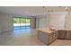 Open concept kitchen with island, stainless steel appliances, and view to backyard at 3937 Reed Grass Pl, Kissimmee, FL 34746