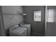 Laundry room with washer, dryer, and overhead shelving at 3937 Reed Grass Pl, Kissimmee, FL 34746
