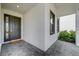 Side view of modern front entrance with dark-colored door at 2409 Shanti Dr, Kissimmee, FL 34746