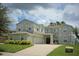 Two-story house with a three car garage and manicured lawn at 13900 Fox Glove St, Winter Garden, FL 34787