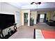 Primary bedroom suite with large TV, ensuite bathroom, and sitting area at 13900 Fox Glove St, Winter Garden, FL 34787