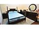 Guest bedroom with a dark wood frame bed, and plenty of space at 13900 Fox Glove St, Winter Garden, FL 34787