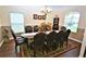 Formal dining room with dark wood table and chairs, hardwood floors, and chandelier at 13900 Fox Glove St, Winter Garden, FL 34787