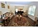 Bright living room with hardwood floors, neutral walls and elegant furnishings at 13900 Fox Glove St, Winter Garden, FL 34787