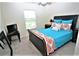 Cozy bedroom with a queen-size bed and ample natural light at 13900 Fox Glove St, Winter Garden, FL 34787