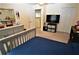 Spacious bedroom with a double bed, dresser, and access to a hallway at 13900 Fox Glove St, Winter Garden, FL 34787