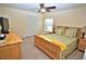 Large bedroom with a queen bed, dresser, and plenty of natural light at 13900 Fox Glove St, Winter Garden, FL 34787