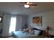 Spacious bedroom with large bed, window, and ceiling fan at 924 Derbyshire Dr, Kissimmee, FL 34758