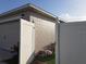 View of the side yard with access gate and garage at 924 Derbyshire Dr, Kissimmee, FL 34758
