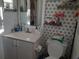 Clean bathroom with toilet, sink, and decorative tile at 924 Derbyshire Dr, Kissimmee, FL 34758