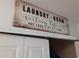 Laundry room with washer, dryer, and storage shelves at 924 Derbyshire Dr, Kissimmee, FL 34758