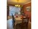 Elegant dining room featuring a large table, chandelier, and orange accents at 662 Rosselli Blvd, Davenport, FL 33896