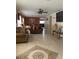 Open living and dining area with tiled floors and a large screen TV at 662 Rosselli Blvd, Davenport, FL 33896