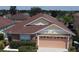 Two-story house with a peach garage door and a nicely landscaped front yard at 662 Rosselli Blvd, Davenport, FL 33896