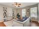 Living room with hardwood floors, comfortable seating, and large windows at 6943 Cupseed Ln, Harmony, FL 34773