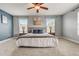 Large bedroom with a ceiling fan and neutral color palette at 6943 Cupseed Ln, Harmony, FL 34773