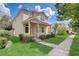 Two-story house with a front porch, landscaping, and a large yard at 6943 Cupseed Ln, Harmony, FL 34773