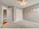 Bedroom with ceiling fan, carpet, and double door closet at 6943 Cupseed Ln, Harmony, FL 34773