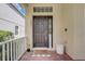 Front entry with dark brown door and welcome mat at 6943 Cupseed Ln, Harmony, FL 34773