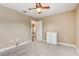 Spacious bedroom with ceiling fan and access to another room at 6943 Cupseed Ln, Harmony, FL 34773