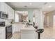 Open concept kitchen with island, stainless steel appliances and views to dining and living areas at 6943 Cupseed Ln, Harmony, FL 34773