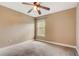Bedroom with ceiling fan, carpet flooring, and window at 6943 Cupseed Ln, Harmony, FL 34773