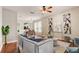 Living room with hardwood floors, comfortable seating, and large windows at 6943 Cupseed Ln, Harmony, FL 34773