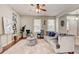 Bright living room with comfy seating, large windows, and stylish decor at 6943 Cupseed Ln, Harmony, FL 34773