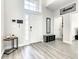 Bright entryway with gray flooring, a white door, and shoe storage at 107 Julliard Blvd, Davenport, FL 33897