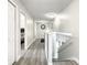 Upstairs hallway with gray floors and access to bedrooms at 107 Julliard Blvd, Davenport, FL 33897