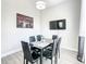 Modern dining area with glass top table and six black chairs at 107 Julliard Blvd, Davenport, FL 33897