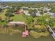 Aerial view of waterfront home with private dock and expansive lot at 955 Mansfield Rd, Tavares, FL 32778