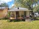 Small house with porch and yard, needs renovation at 6936 Wilson Ave, Mulberry, FL 33860