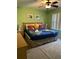 King-size bed, nightstands, and ceiling fan in this bedroom at 718 Verona Ave, Davenport, FL 33897