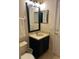 Vanity with sink, mirror and dark blue cabinetry at 718 Verona Ave, Davenport, FL 33897