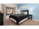Cozy bedroom with a full-size bed and calming blue accent wall at 3148 Pequod Pl, Kissimmee, FL 34746