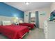 Two twin beds in a bright bedroom with blue and beige walls at 3148 Pequod Pl, Kissimmee, FL 34746