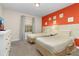 Two twin beds in a bedroom with an orange accent wall at 3148 Pequod Pl, Kissimmee, FL 34746