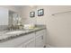Bathroom with granite countertop, white cabinets, and shower at 3148 Pequod Pl, Kissimmee, FL 34746