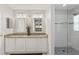 Elegant bathroom with double sinks, granite countertop, and a walk-in shower at 384 Grand Canal Dr, Poinciana, FL 34759