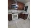 Kitchen with granite countertops, wooden cabinets, and appliances at 1520 Hill St, Kissimmee, FL 34741