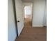 Long hallway with light wood laminate flooring at 1565 Channell Dr, Mount Dora, FL 32757