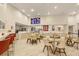 Community room with tables, chairs, and a large screen TV at 7395 Universal Blvd # 103, Orlando, FL 32819
