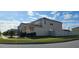Two-story house with solar panels and landscaped yard at 2585 Needlepoint St, Kissimmee, FL 34741