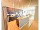 Spacious kitchen with dark cabinets, granite countertops, and tile floors at 2585 Needlepoint St, Kissimmee, FL 34741