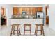 Kitchen with granite countertop, wood cabinets, and breakfast bar at 1134 Tapestry Dr, Celebration, FL 34747