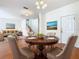 Bright dining room features hardwood floors and a charming round table, perfect for Gathering meals at 1134 Tapestry Dr, Celebration, FL 34747