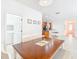 Dining area with wood table, white chairs, and view of kitchen at 1134 Tapestry Dr, Celebration, FL 34747